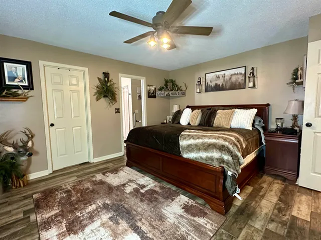 a bedroom with a bed and a ceiling fan
