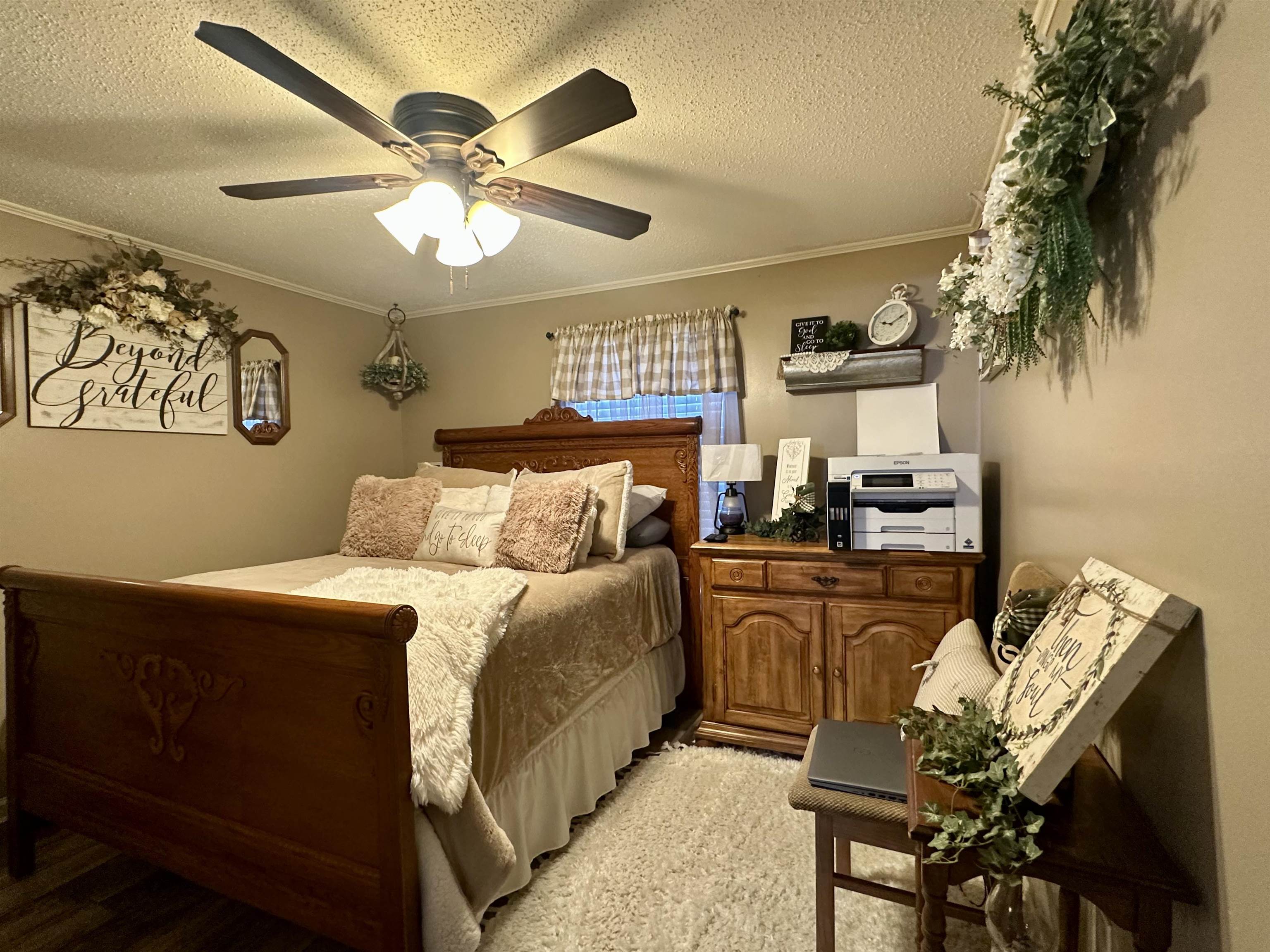 4769 Pleasant Site Road Selmer, TN 38375 - Photo 18 of 28 a bedroom with furniture and a chandelier