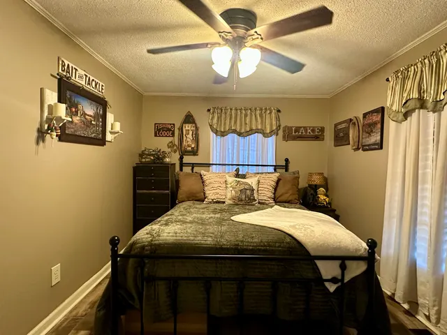 a bed sitting in a bedroom next to a window