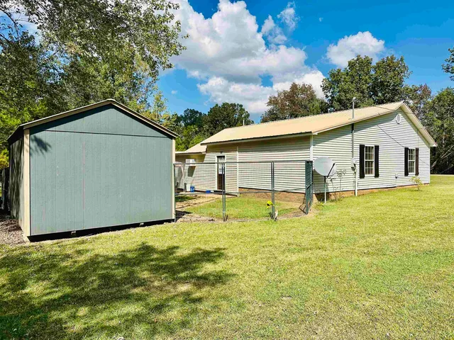 a view of a house with a yard porch and sitting area