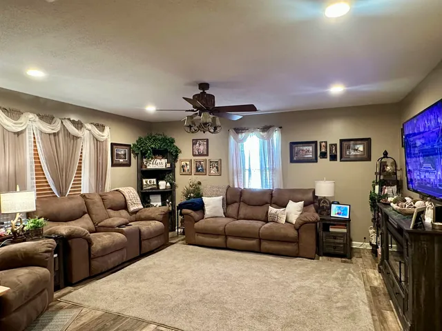 a living room with furniture and a flat screen tv