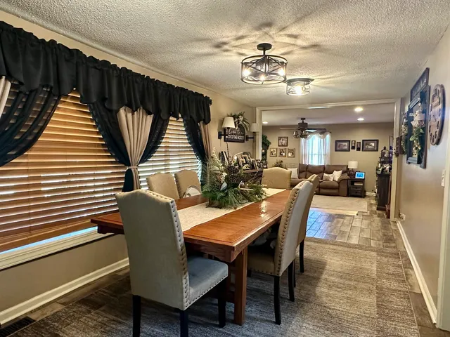a dining room with furniture and wooden floor