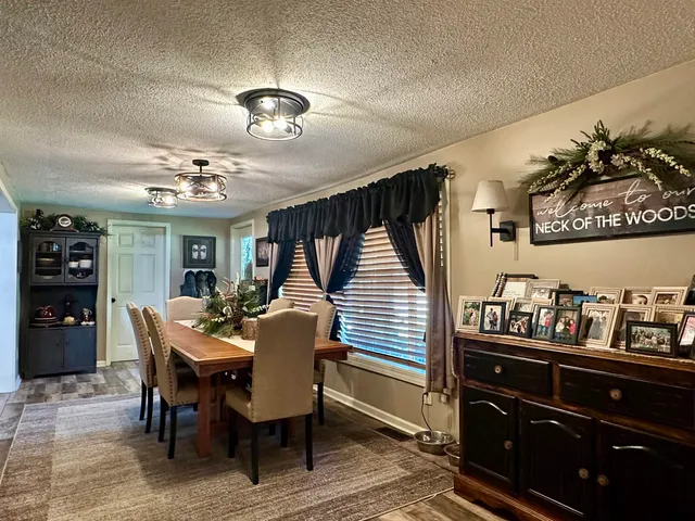 a dining room with furniture and chandelier