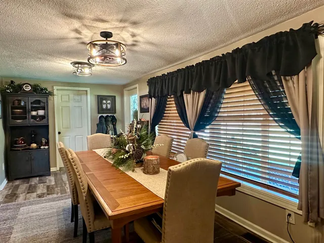 a dinning room with furniture and wooden floor