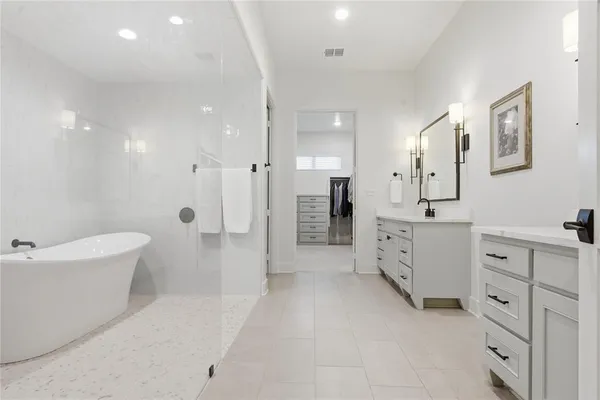 a white bath tub sitting next to a white sink