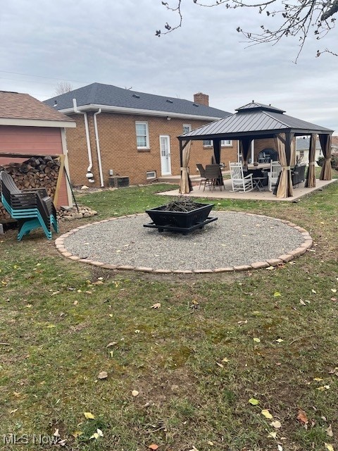 178 Patterson Road Weirton, WV 26062 - Photo 43 of 50 Back of property with a gazebo, a patio, an outdoor fire pit, and a lawn