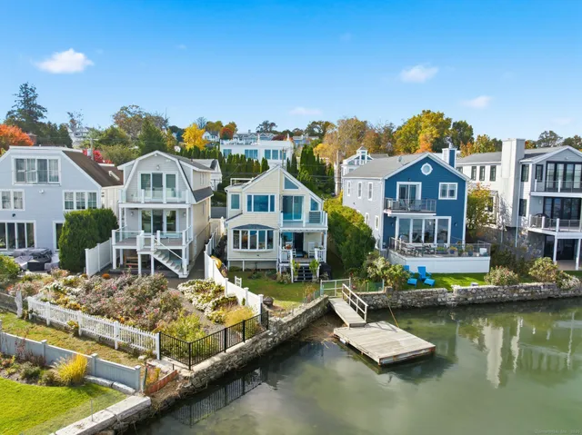 a view of houses with a water fall and swimming pool