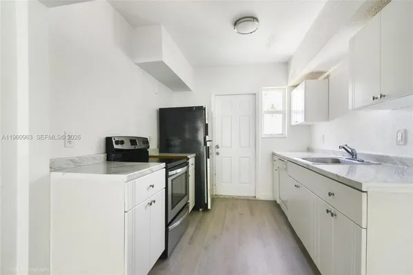 a kitchen with a sink a stove and refrigerator