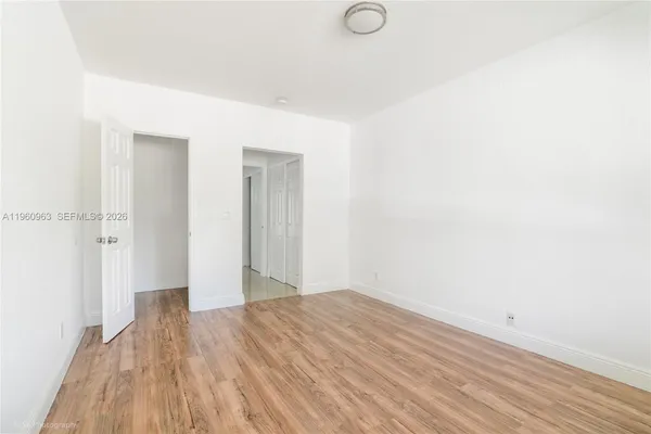 a view of a room with wooden floor