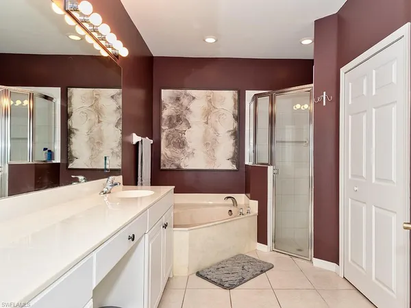 a bathroom with a sink a large mirror and a shower