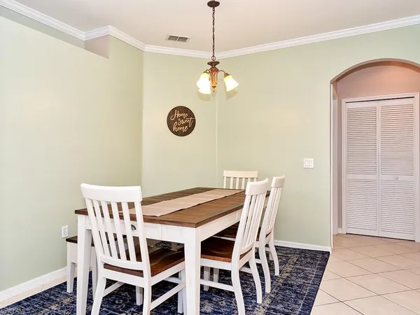 a view of a dining room with furniture and a chandelier