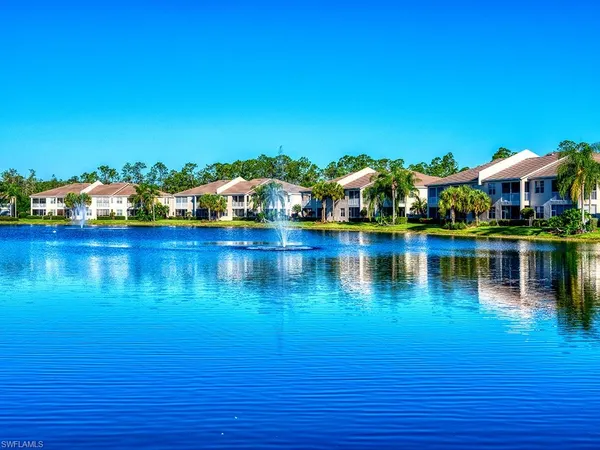 an aerial view of residential houses with outdoor space and swimming pool