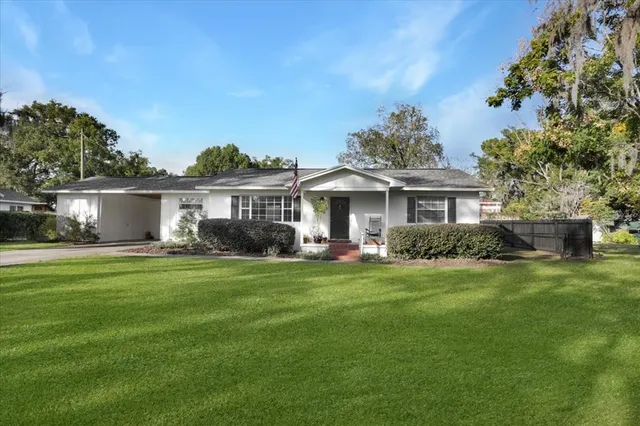 a front view of a house with a garden