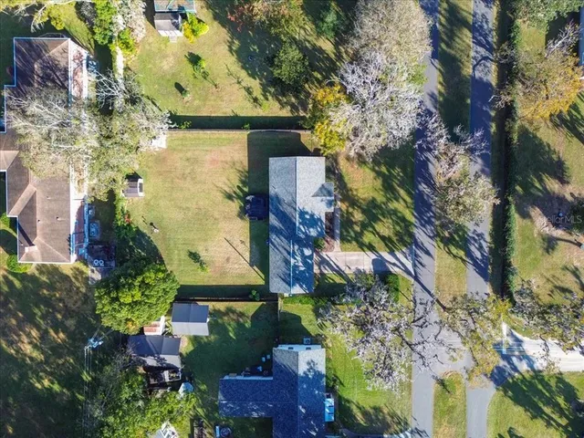 an aerial view of a house with a yard
