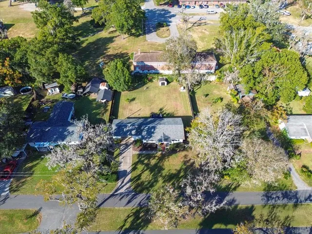 a aerial view of a house with a yard and lake view