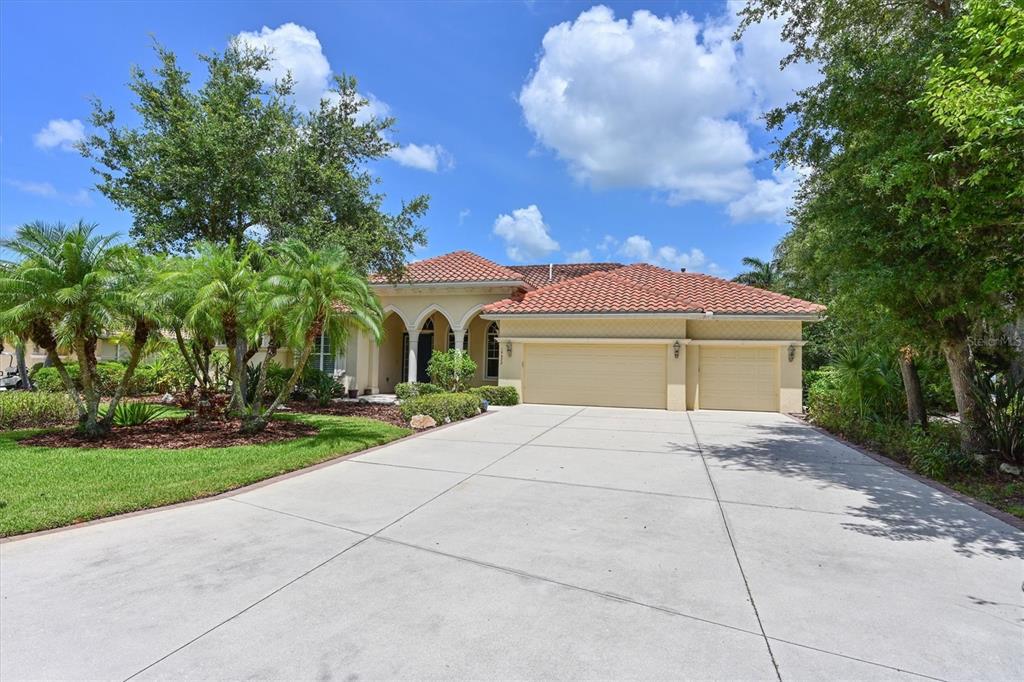 10622 Conch Shell Terrace Bradenton, FL 34212 - Photo 2 of 69 a front view of a house with a yard and a garage