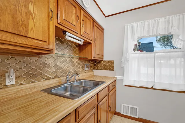 a kitchen with stainless steel appliances granite countertop a sink and a microwave