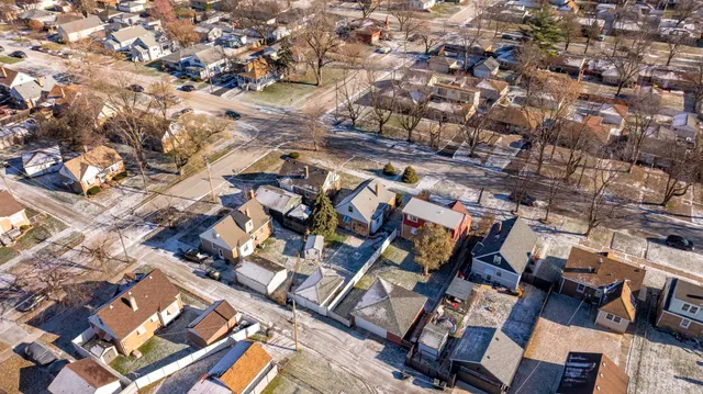 an aerial view of house with yard and mountain view in back