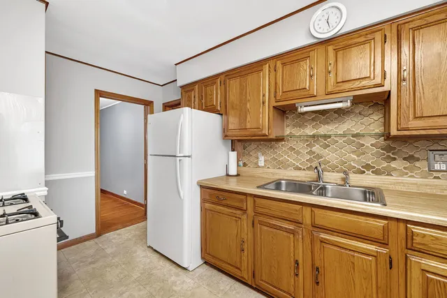 a kitchen with stainless steel appliances granite countertop a refrigerator a stove a sink and dishwasher