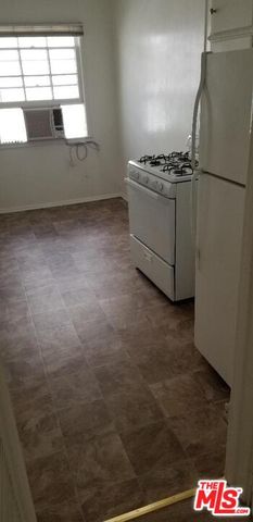 a kitchen with cabinets and white appliances