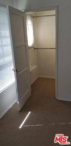 a kitchen with granite countertop white cabinets and a wooden floor
