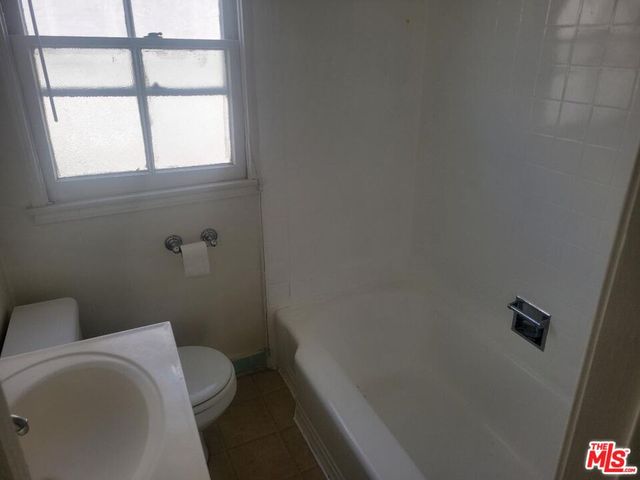 a kitchen with a stove a sink and a window