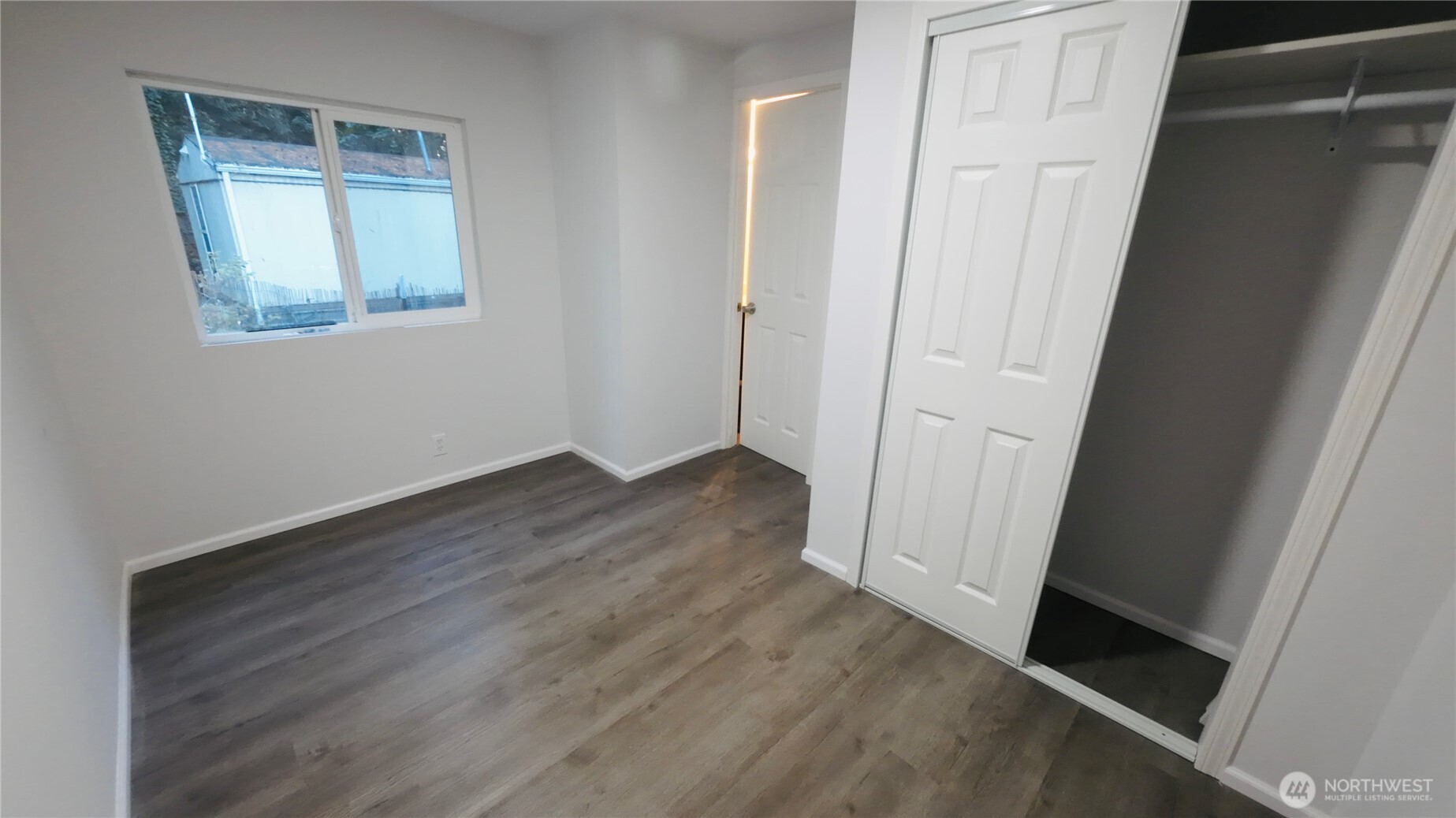 6800 Enterprise, Unit 9 Ferndale, WA 98248 - Photo 11 of 22 an empty room with wooden floor and mirror