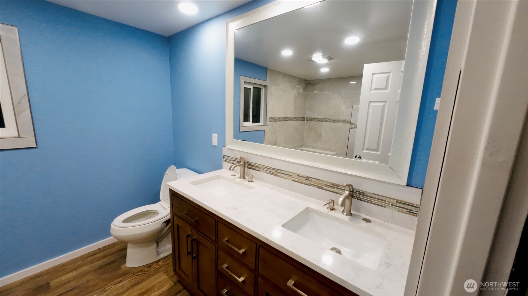 6800 Enterprise, Unit 9 Ferndale, WA 98248 - Photo 17 of 22 a bathroom with a sink a toilet a mirror and vanity