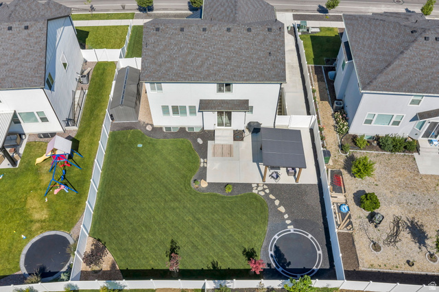252 North Sunrise Rnch Drive Mapleton, UT 84664 - Photo 59 of 62 Expansive backyard featuring a manicured lawn, established patio with a pergola, decorative rock landscaping, and a privacy fence