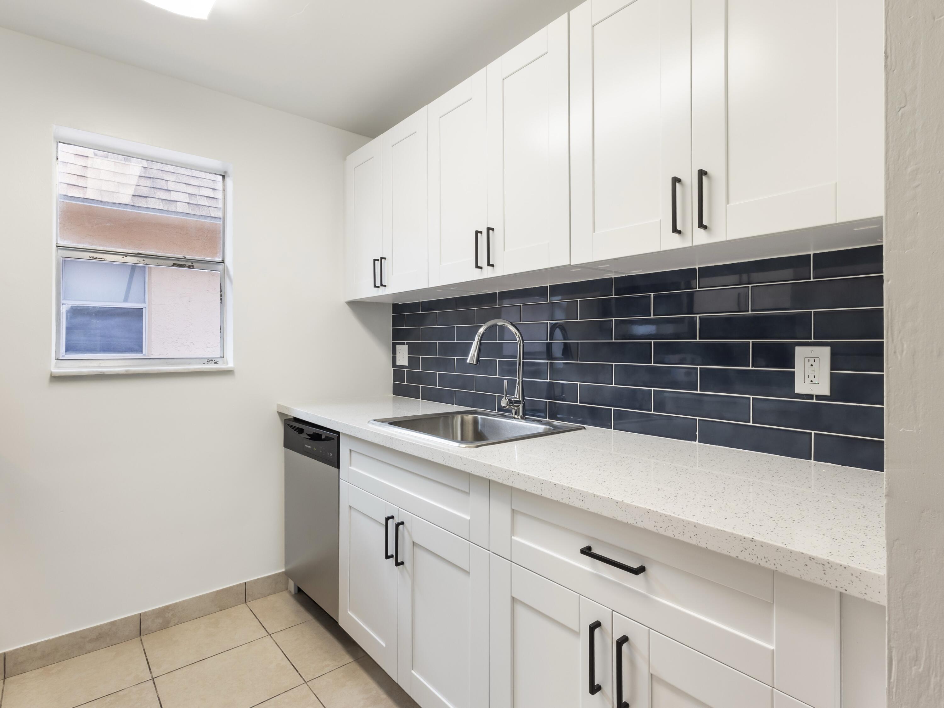 450 Southwest 2nd Avenue, Unit 2050 Boca Raton, FL 33432 - Photo 1 of 11 a close view of a sink and dishwasher with white cabinets