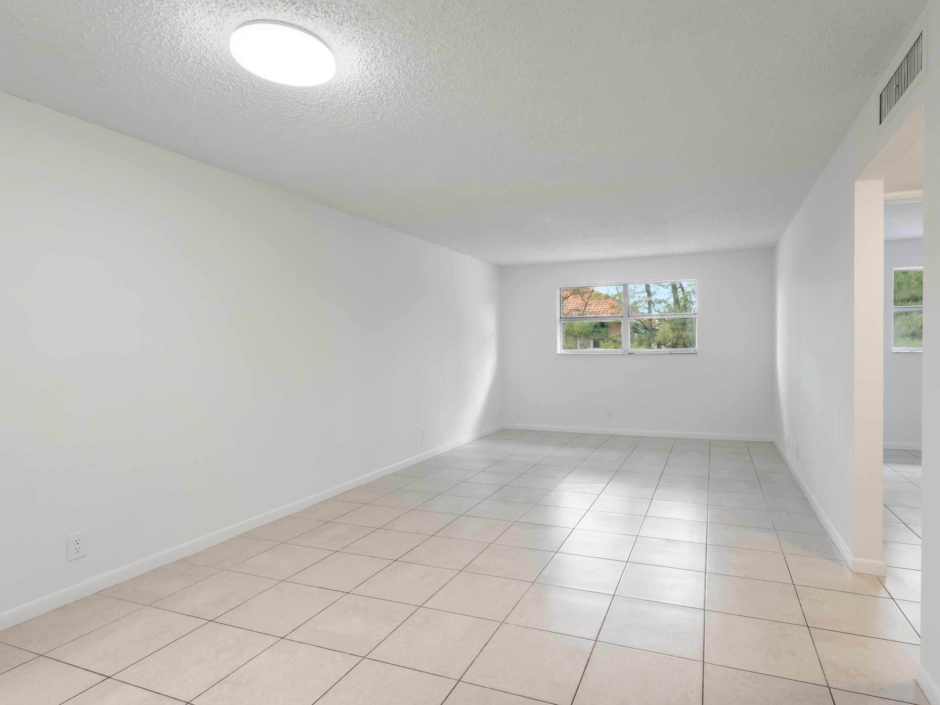 450 Southwest 2nd Avenue, Unit 2050 Boca Raton, FL 33432 - Photo 6 of 11 an empty room with windows