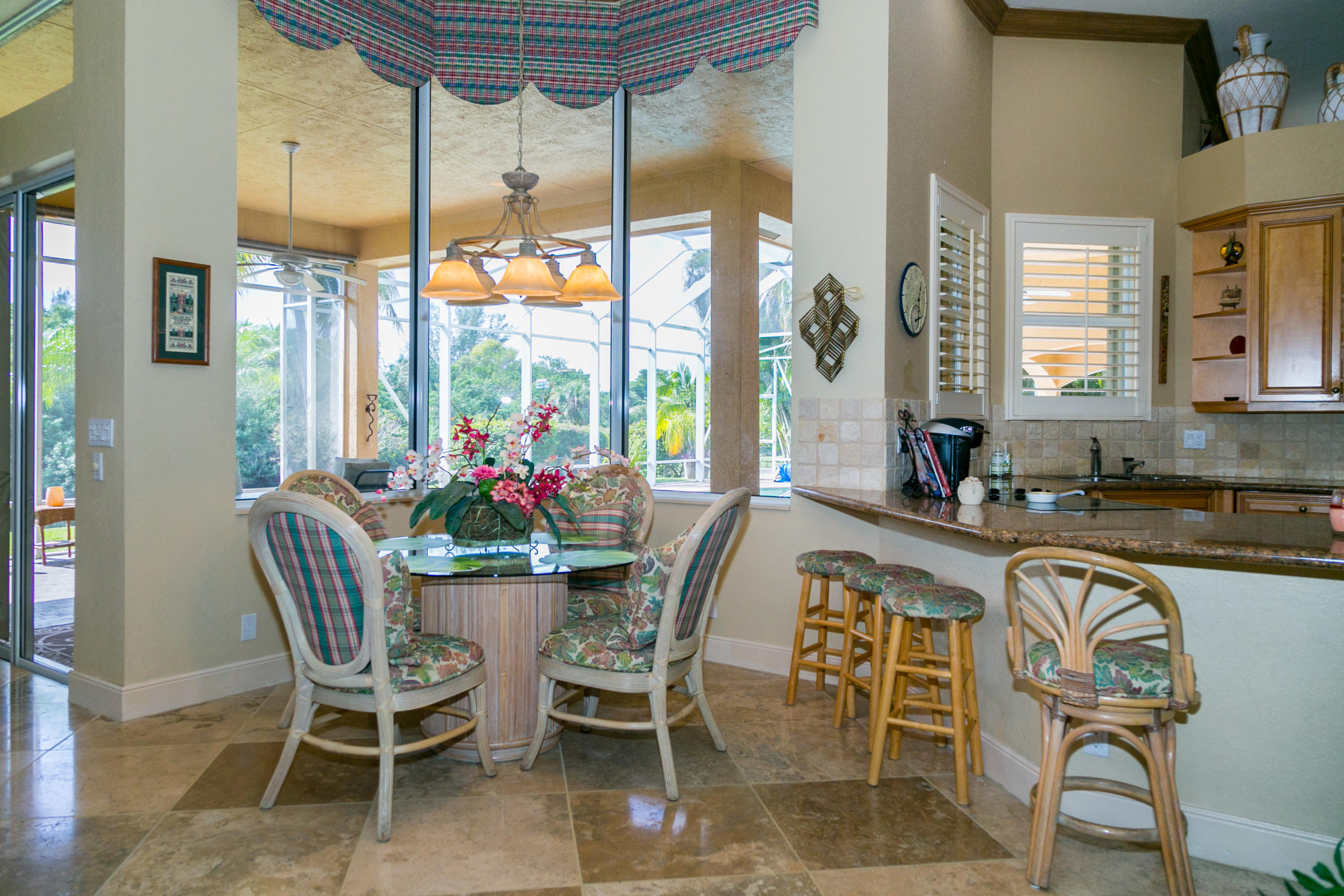 8666 Sawpine Road Delray Beach, FL 33446 - Photo 11 of 49 a dining room with furniture a chandelier and wooden floor