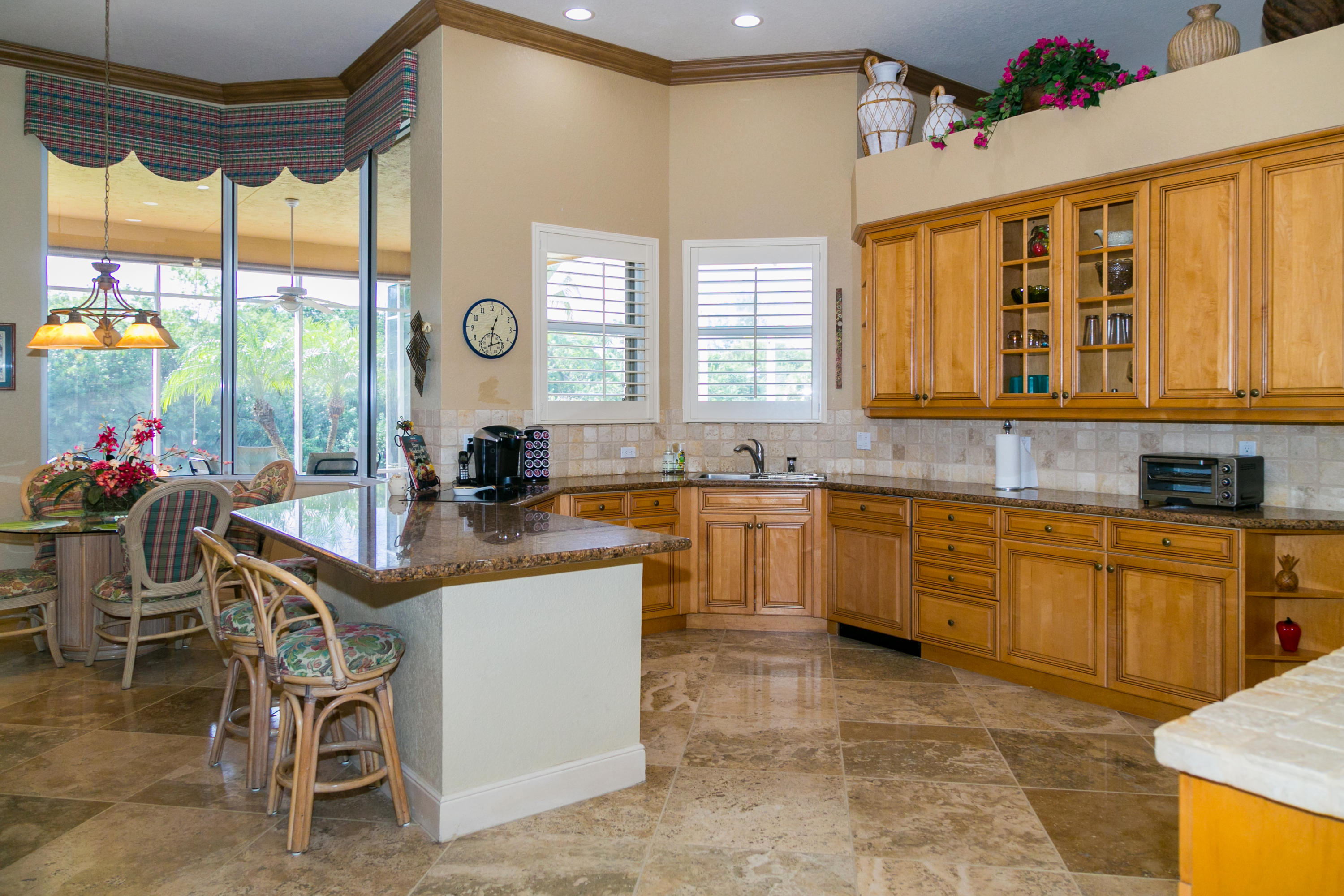 8666 Sawpine Road Delray Beach, FL 33446 - Photo 13 of 49 a kitchen with a sink and chairs