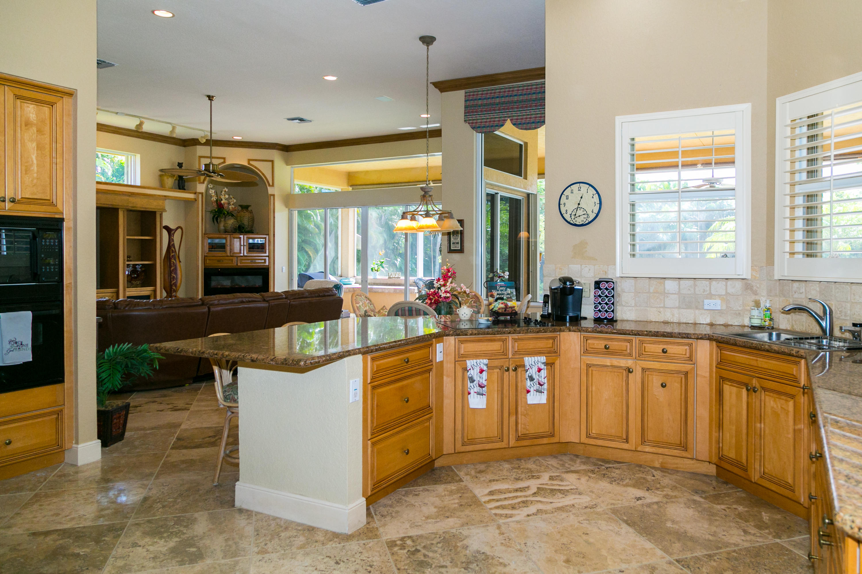 8666 Sawpine Road Delray Beach, FL 33446 - Photo 16 of 49 a kitchen with stainless steel appliances granite countertop a sink and a refrigerator