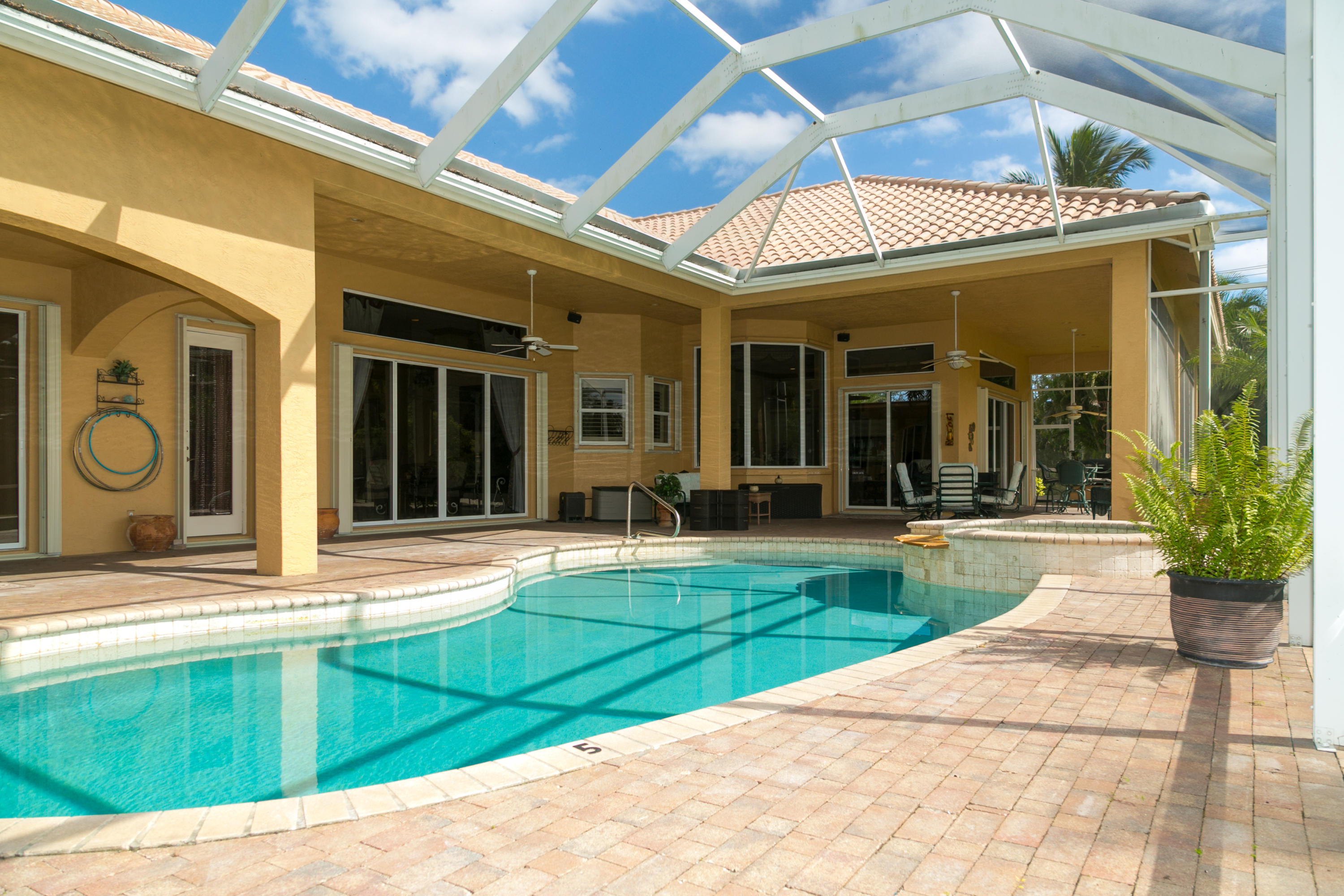 8666 Sawpine Road Delray Beach, FL 33446 - Photo 2 of 49 a view of a building with door and outdoor seating