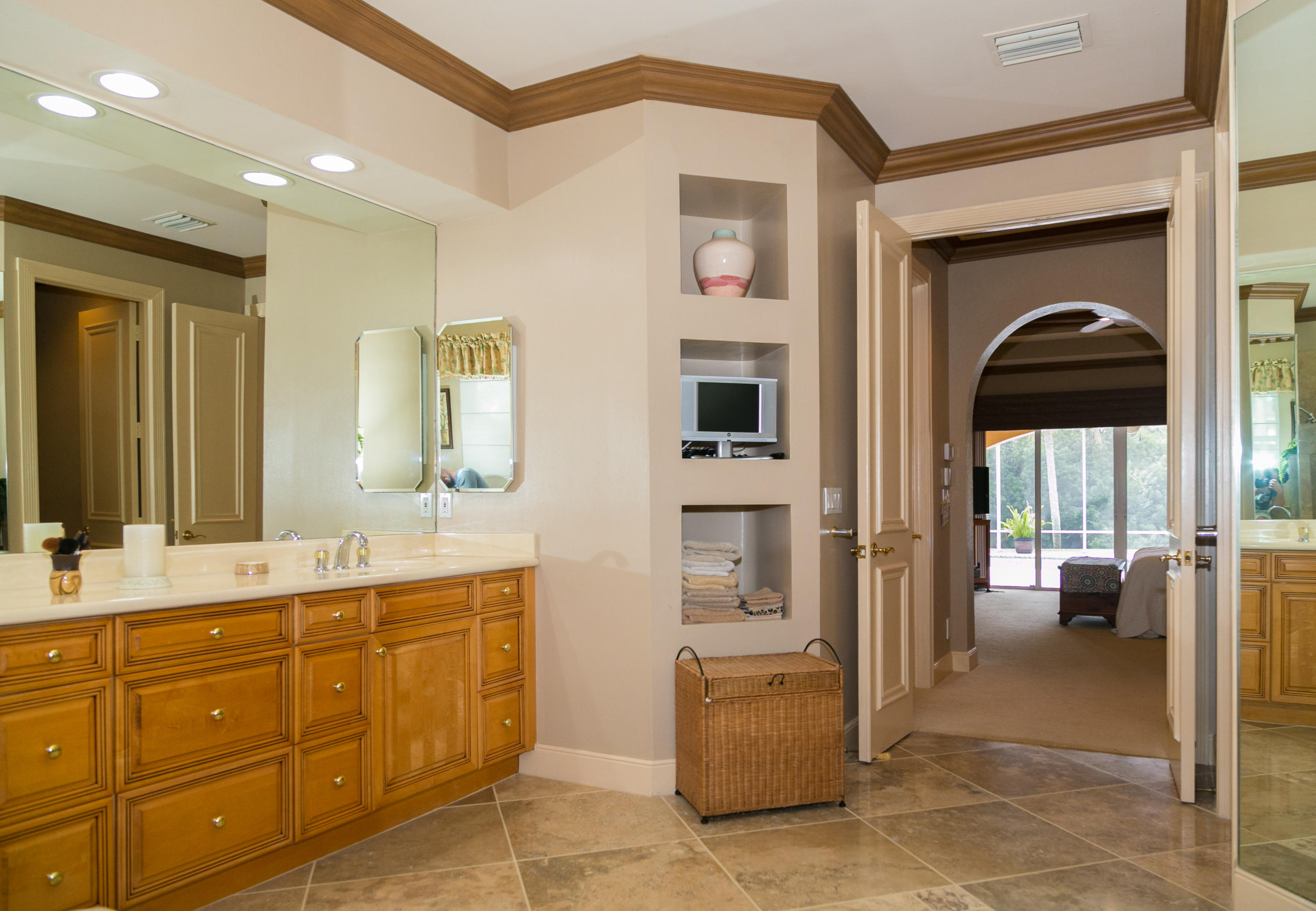 8666 Sawpine Road Delray Beach, FL 33446 - Photo 25 of 49 a en suite bathroom with a sink a mirror and a faucet