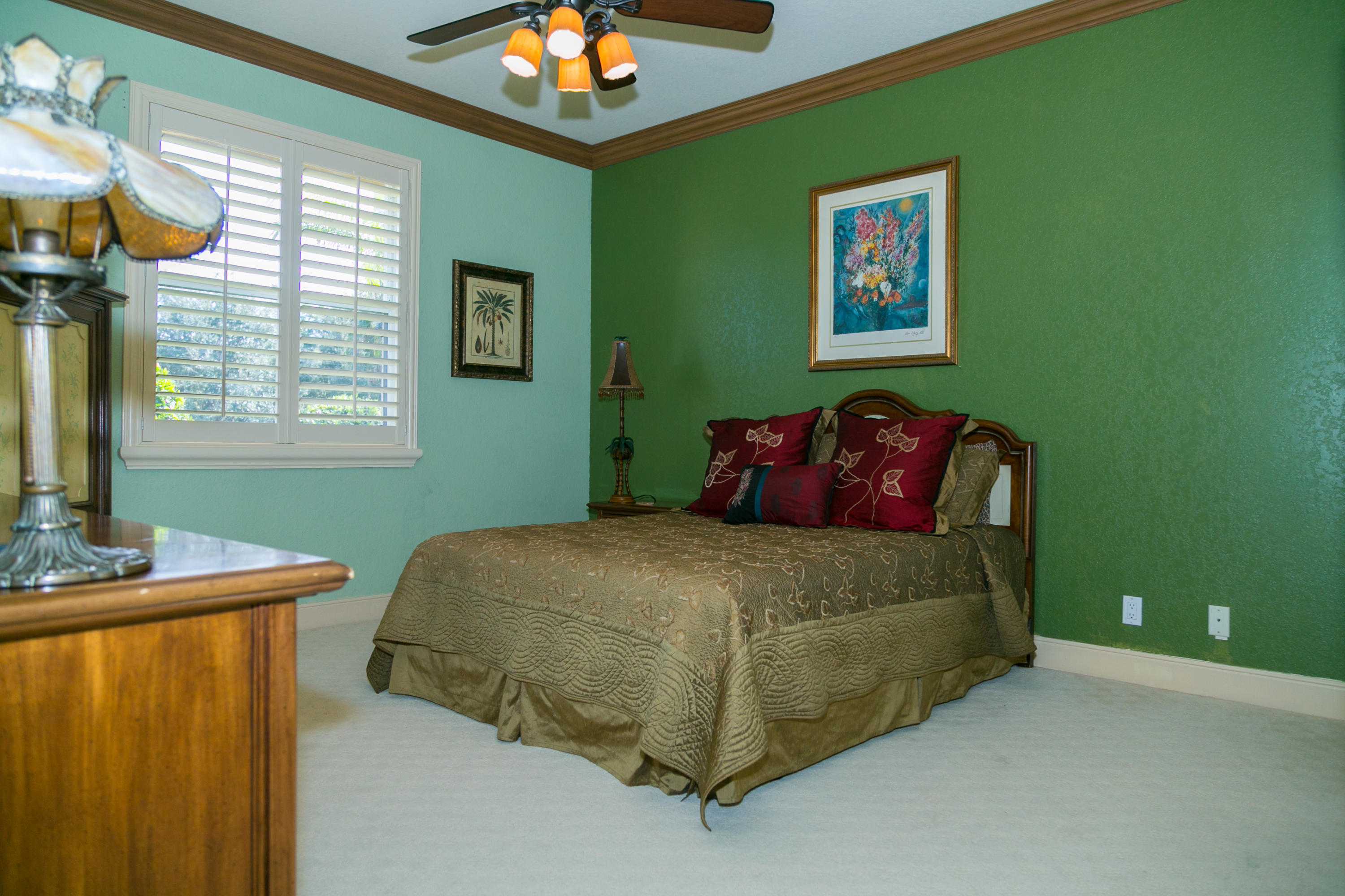 8666 Sawpine Road Delray Beach, FL 33446 - Photo 26 of 49 a bedroom with a bed and a chandelier