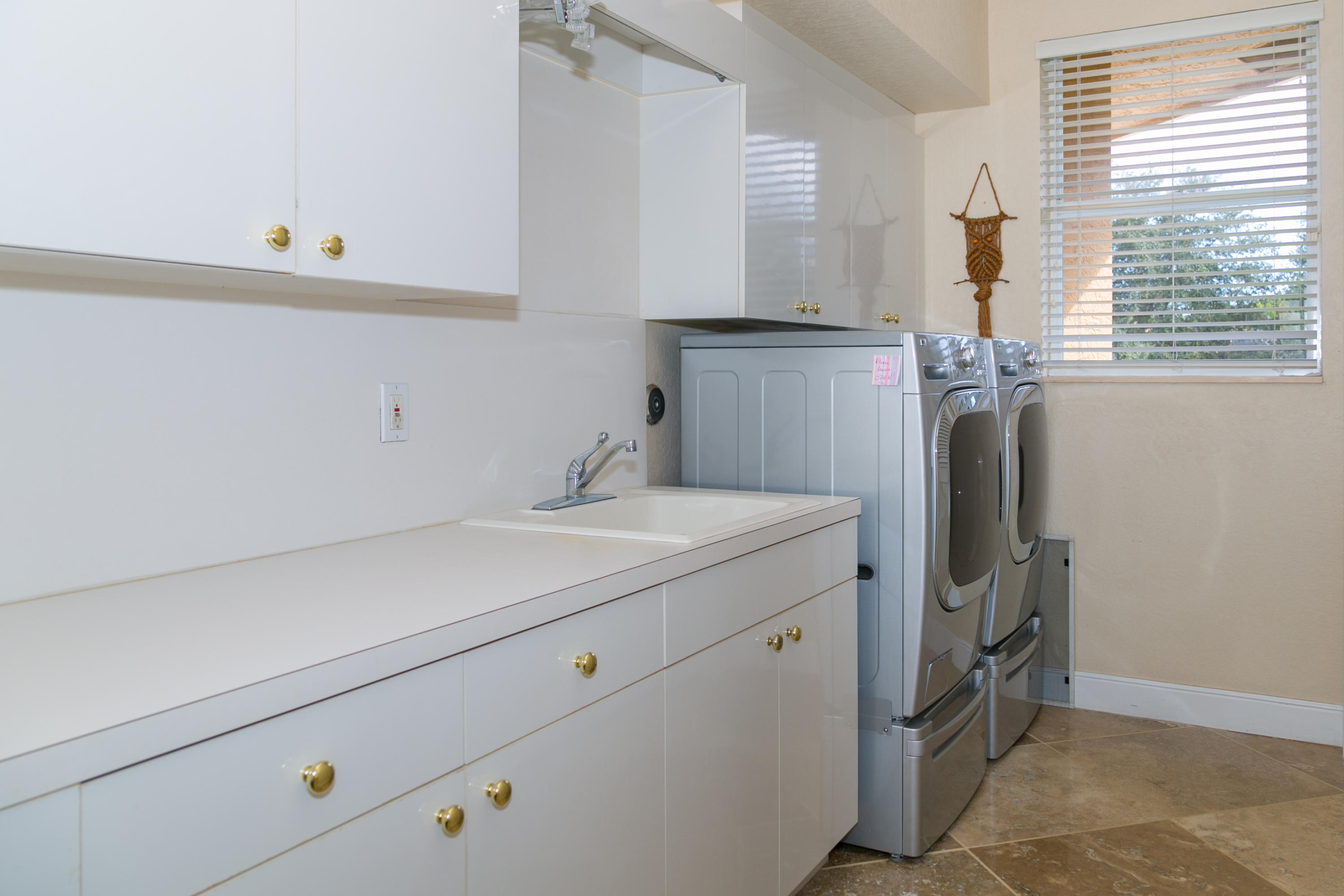 8666 Sawpine Road Delray Beach, FL 33446 - Photo 28 of 49 a utility room with cabinets washer and dryer
