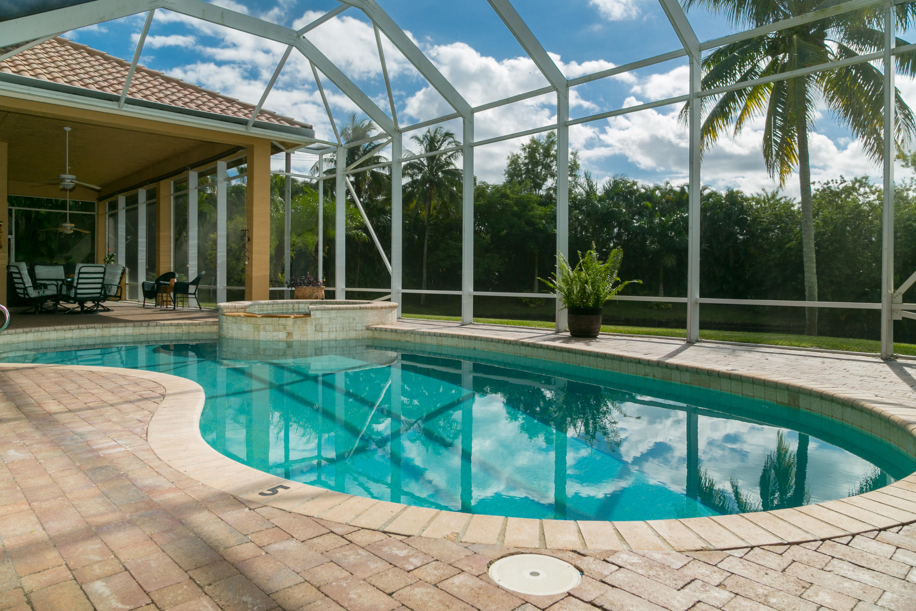 8666 Sawpine Road Delray Beach, FL 33446 - Photo 3 of 49 a view of swimming pool with patio