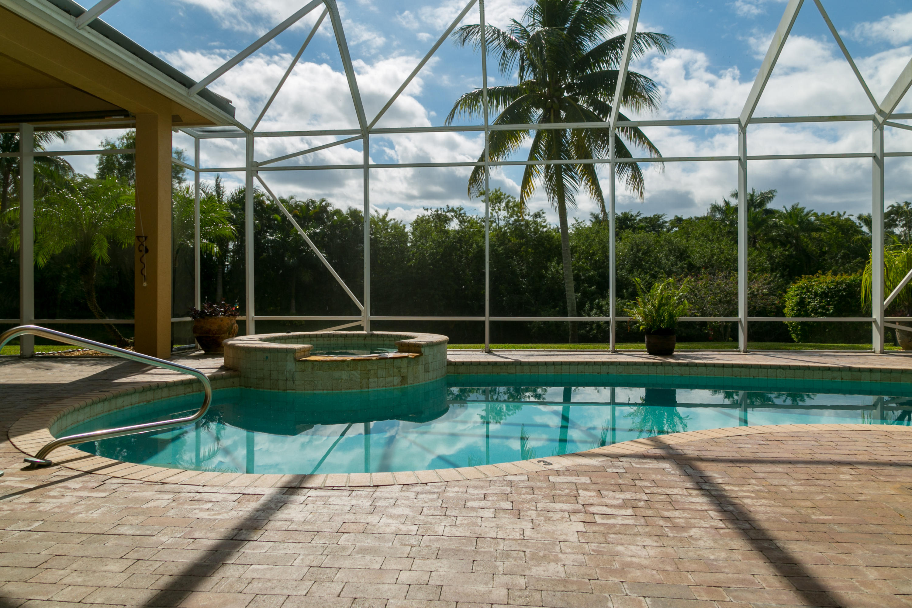 8666 Sawpine Road Delray Beach, FL 33446 - Photo 7 of 49 a view of a chair and tables in the patio