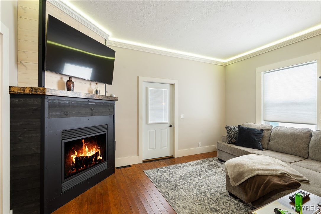 6707 East Lake Road Castile, NY 14427 - Photo 19 of 38 Living room with fireplace and door to patio area