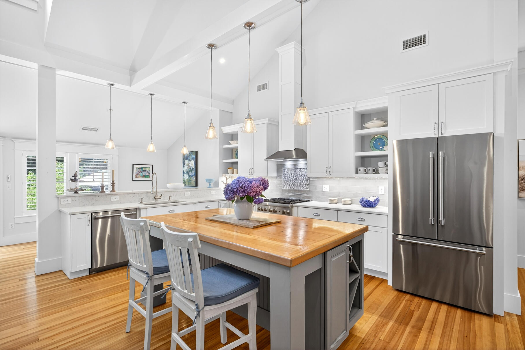 950 Massasoit Road Eastham, MA 02642 - Photo 11 of 66 a kitchen with stainless steel appliances granite countertop a table chairs stove and refrigerator
