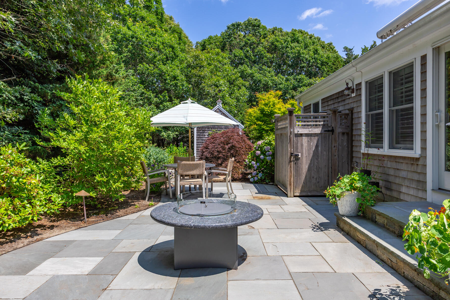 950 Massasoit Road Eastham, MA 02642 - Photo 26 of 66 a view of a chair and table in backyard with plants