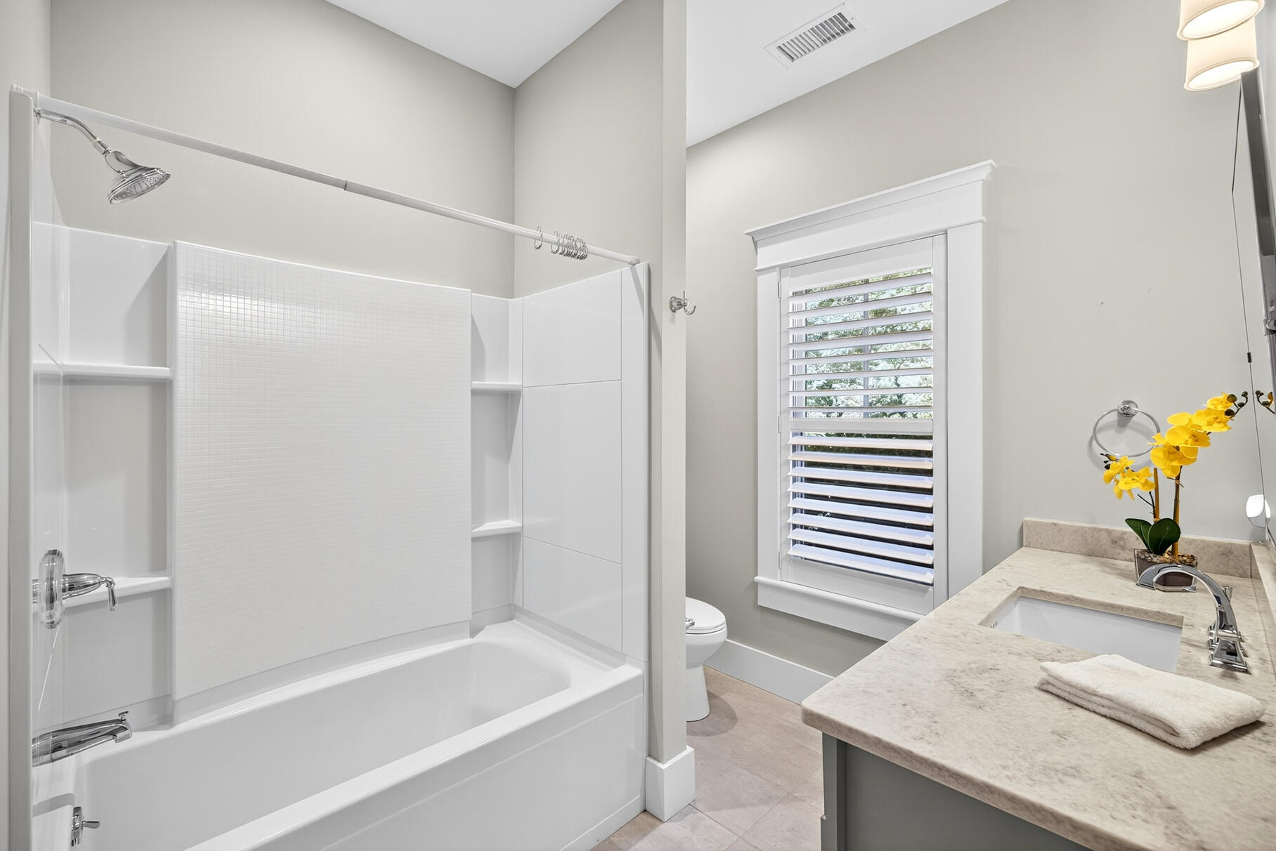 950 Massasoit Road Eastham, MA 02642 - Photo 43 of 66 a bathroom with a granite countertop sink and a bathtub