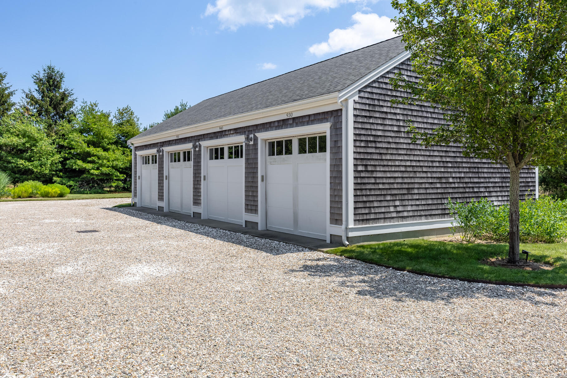 950 Massasoit Road Eastham, MA 02642 - Photo 63 of 66 a front view of a house with a yard and garage