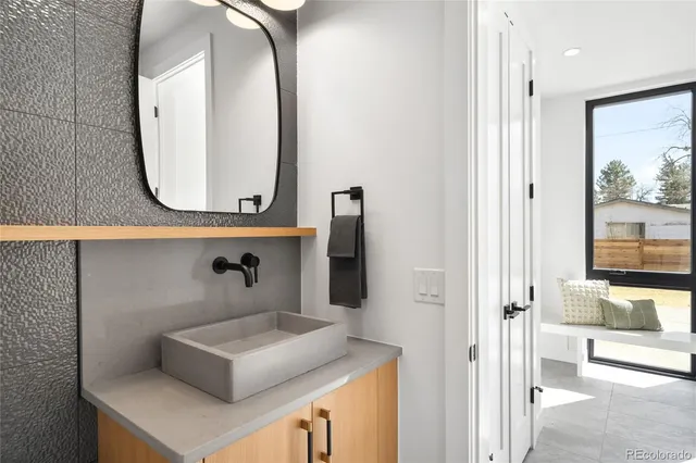 a bathroom with a sink and a mirror with toilet