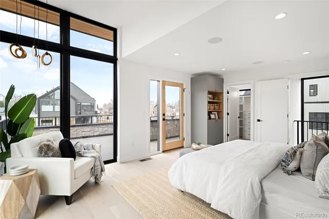 a spacious bedroom with a large bed and a large window