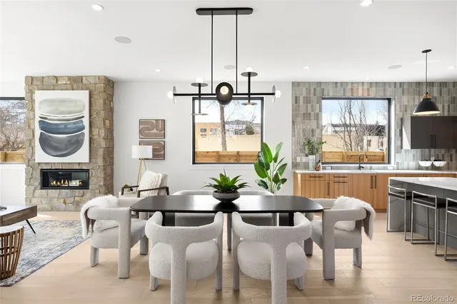 a dining room with furniture a chandelier and window