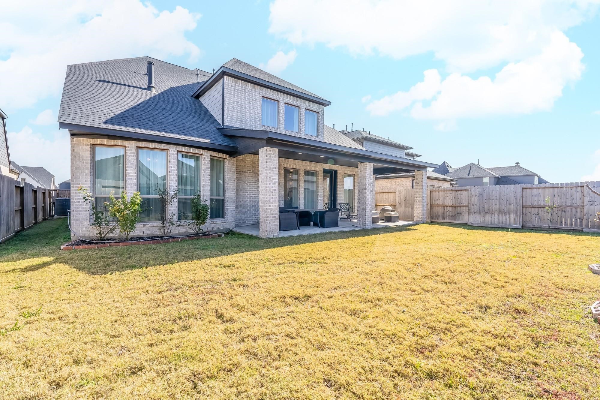 4118 Ana Ridge Lane Fulshear, TX 77441 - Photo 48 of 49 a view of a brick house with a swimming pool