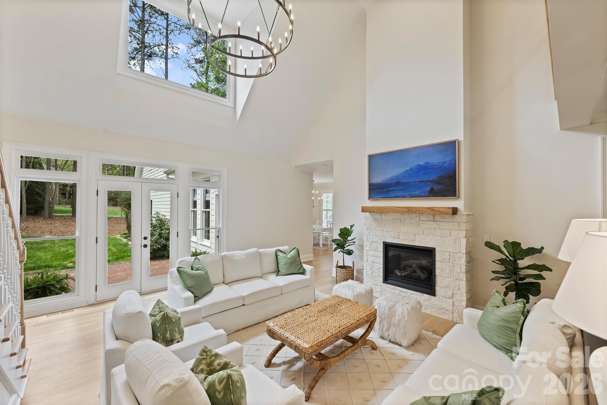 271 Beaten Path Road Mooresville, NC 28117 - Photo 13 of 47 a living room with furniture a fireplace and a floor to ceiling window